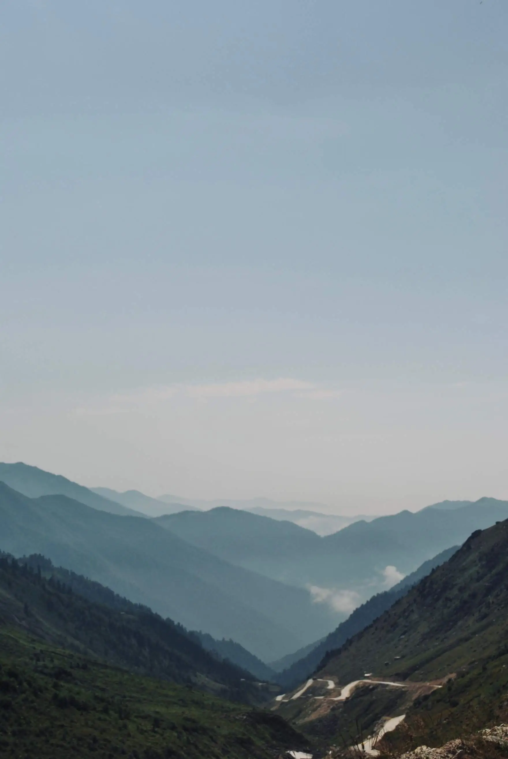 Hazy blue-green mountain ridges receding into the distance.